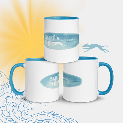 Three white mugs with blue handles featuring 'surf's up whippet' text on a beach background.