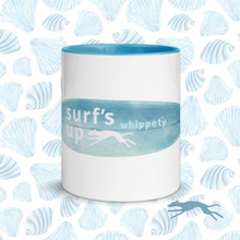 White mug with blue interior and 'surf's up whippety' text on blue shell pattern background