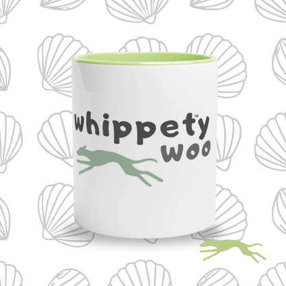 White with green mug with 'whippety woo' text and whippet shape on a shell-themed background