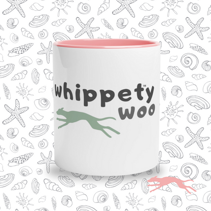 White mug with 'whippety woo' text and whippet shape on a shell-themed background